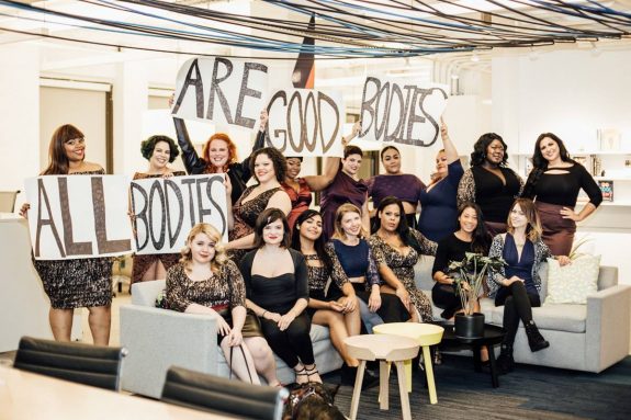 diverse women holding signs saying all bodies are good bodies
